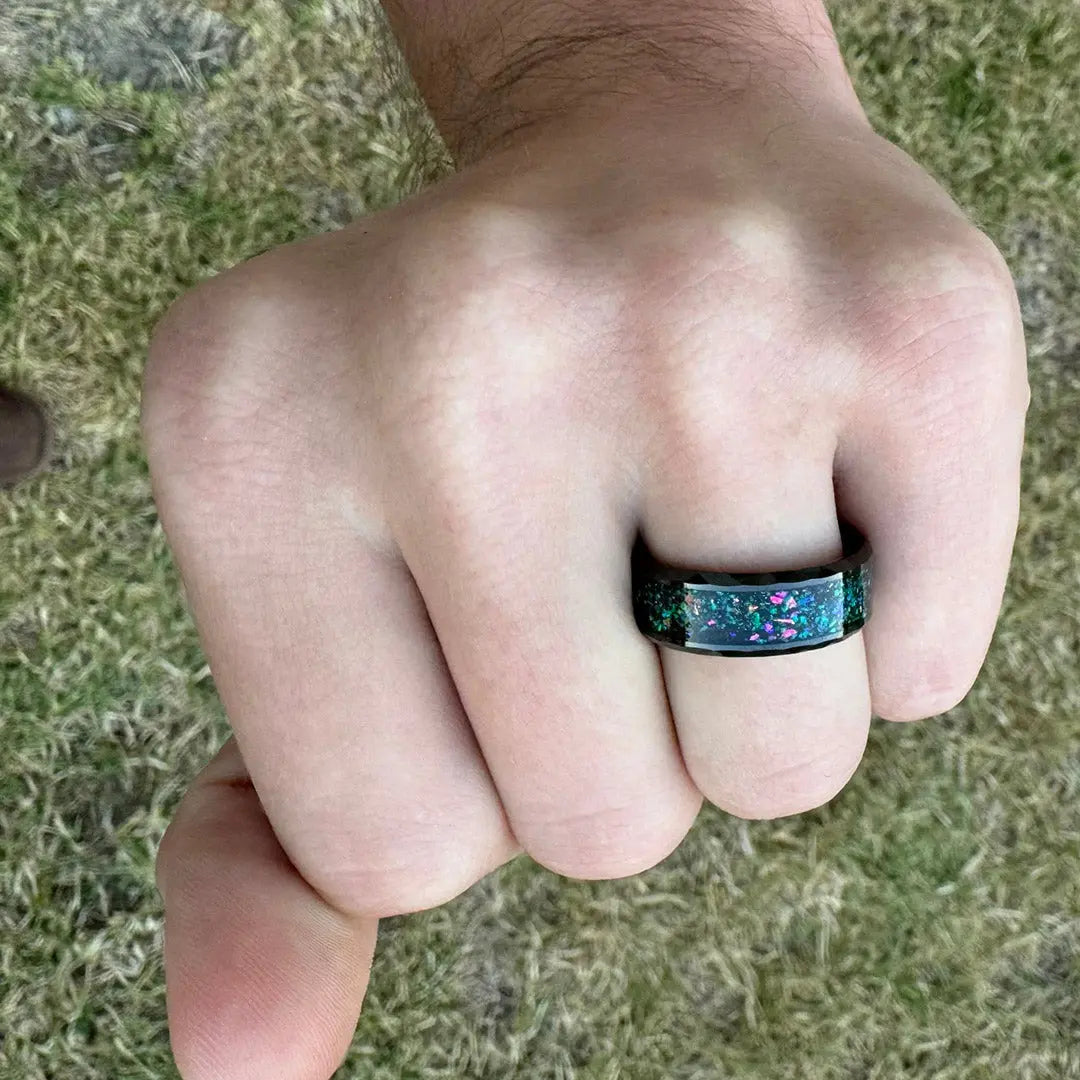 Black Tungsten Opal Wedding Ring for Men – Bold and durable black tungsten wedding band featuring an inlaid opal strip, combining modern design with vibrant, iridescent colors. Perfect for grooms seeking a unique and stylish ring.
