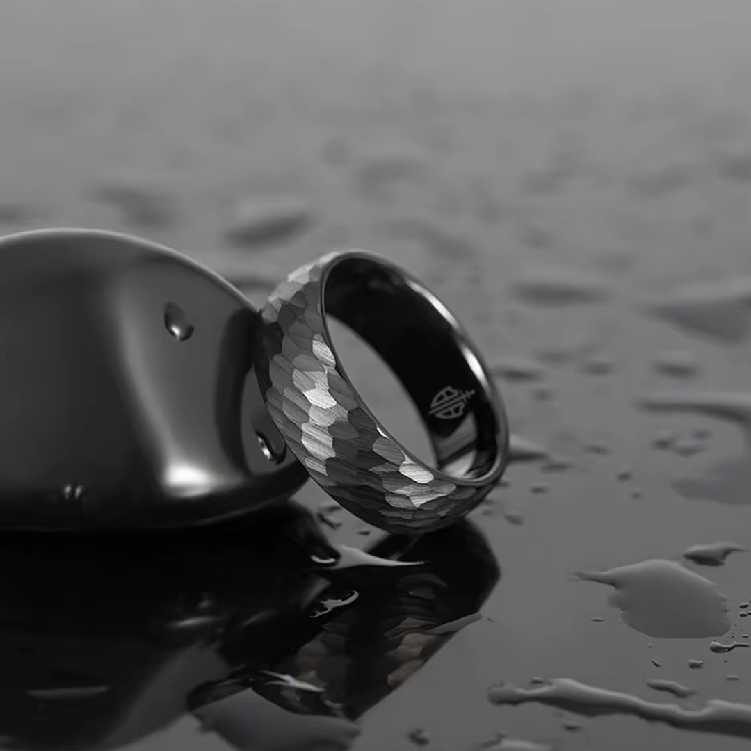 Men's wedding band made with hammered black tungsten.