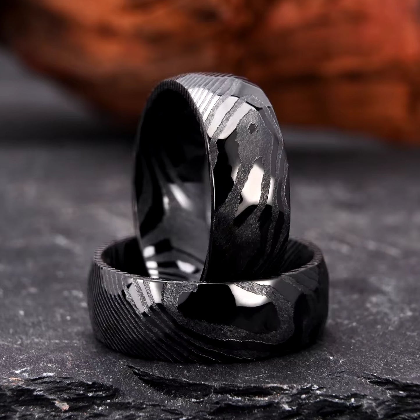 Men's wedding band made with hammered black Damascus steel