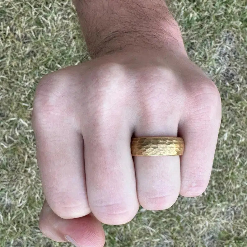 Hammered gold tungsten men's wedding ring – a durable and stylish band with a unique textured finish for a modern wedding look.